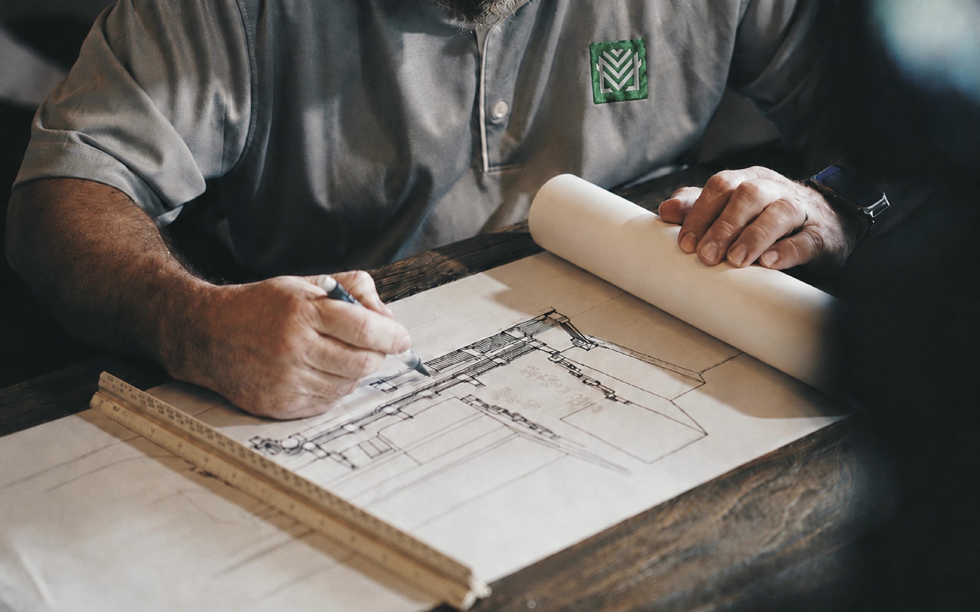 Metalleve team member reviewing and marking architectural project plans