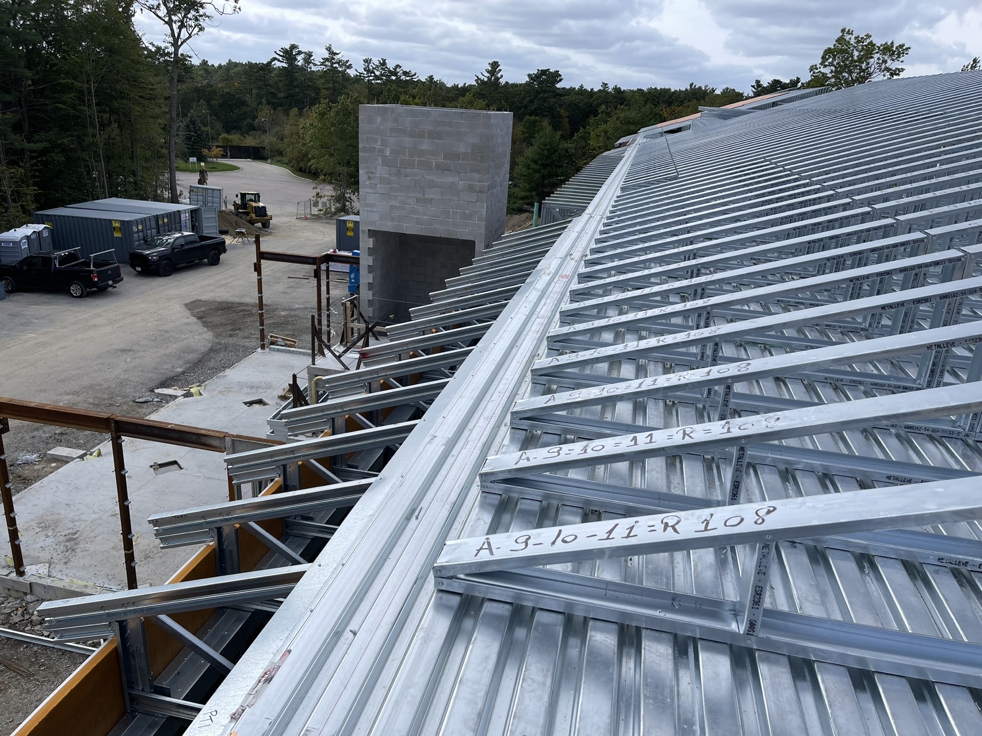 Sloped CFS roof framing coordinated around roof geometry and structural supports